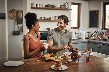 Image showing Happy interracial couple, breakfast and morning in kitchen for healthy meal, talk or bonding at home. Man and woman smiling for coffee, conversation or tea and food on weekend together by the table