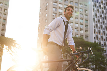 Image showing Cycling, morning and business man in city for commute, carbon neutral and transportation. Sustainable, professional and travel with male employee walking with bike in urban town for journey and trip