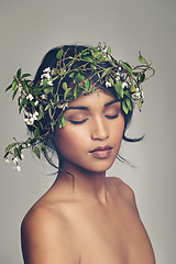 Image showing Beauty, flowers and crown with a woman in studio on a gray background for natural skincare or treatment. Skin, nature and wellness with an attractive young female model wearing a flower wreath