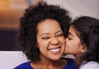 Image showing Kiss, mother and girl with love, bonding and quality time with happiness, home and loving. Family, parent or mama with daughter, female child and kid kissing mom, cheerful and care in the living room