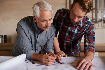 Image showing Architecture team, work on blueprint in workshop with designer and engineering collaboration. Senior architect with male trainee, working on remodeling project with floor plan paperwork and drawing