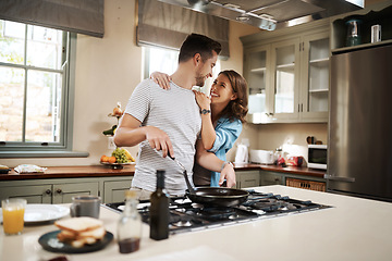 Image showing Love, food and cooking with couple in kitchen and hugging for breakfast, morning and happiness. Smile, care and nutrition with man and woman eating at home for happy, health and hungry together