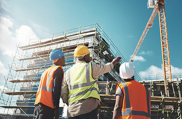 Image showing Engineering, construction site and team outdoor for building project, planning and architecture. Black woman and men contractor together for development and safety assessment discussion in city