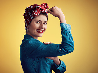 Image showing Strong, pinup girl and flexing muscle portrait in studio for beauty, women power and fashion. Happy female person show bicep on yellow background for motivation, freedom and retro or vintage style