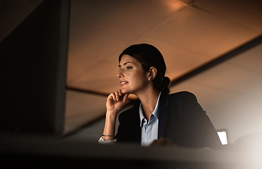 Image showing Thinking, overtime and focus, woman in office reading email or online report idea at start up agency. Corporate night work, challenge and businesswoman at desk working late on computer for job ideas.