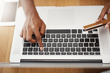 Image showing Hands, laptop and payment with credit card for online shopping, e-commerce or internet store. Closeup of female entrepreneur at desk with keyboard for banking, booking or fintech website for business