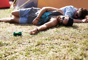 Image showing Drunk, sleeping and men on camping ground at a music festival with alcohol. Field, drinking and lawn with a tent and youth on grass with people and man camper at concert outdoor with cans