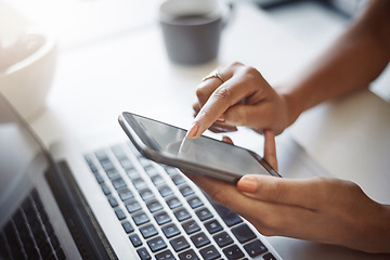 Image showing Woman, hands and phone at a laptop for work networking and employee typing. Female worker, table and social network app with mobile communication and text for professional and web connection