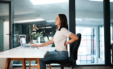 Image showing Back pain, office and business woman with stress, muscle ache and tension in sitting posture. Health, medical emergency and female worker at desk with spine problem, tendinitis and injury on laptop