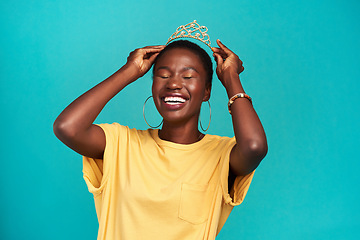 Image showing Crown, happy and excited princess or black woman with happiness isolated in a blue background studio. Celebration, winner and young female person celebrating with a tiara for an achievement or prom