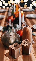 Image showing Pumpkin, thanksgiving and holiday celebration or table in a home dining room with decoration for a party. Season, art and gift background with vegetable, candles and rustic dinner inspiration