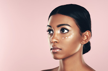 Image showing Thinking, skincare and beauty of woman with cream in studio isolated on pink background mockup space. Dermatology, creme cosmetics and Indian female model with moisturizer lotion for healthy skin.