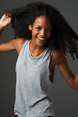 Image showing Portrait, african woman and smile in studio with confidence, good mood and positive personality. Happy female model, beautiful afro hair and casual style for natural beauty, fashion and empowerment