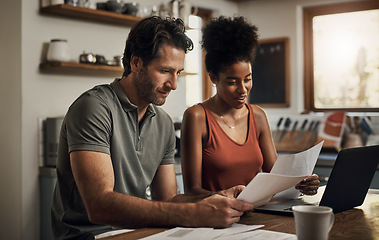 Image showing Finance, couple and laptop in a kitchen for planning, budget and savings or paying bills together in their home. Marriage, online and people with documents for tax, mortgage or home loan or insurance