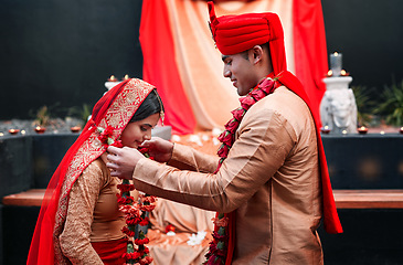 Image showing Wedding, marriage and flowers with a couple together in celebration of love at a ceremony. Happy, romance or islamic with a hindi bride and groom getting married outdoor in tradition of their culture