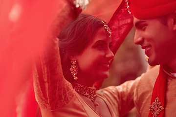 Image showing Wedding, marriage and red veil with couple together in celebration of love at a ceremony. Happy, romance or islamic with a hindu bride and groom getting married outdoor in tradition of their culture