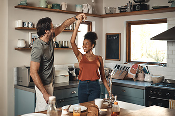 Image showing Interracial couple, dance and love in kitchen for romance, fun bonding or holiday together at home. Happy man and woman dancing in joyful happiness for romantic relationship or enjoying weekend house