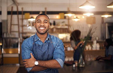 Image showing Coffee shop, crossed arms and portrait of black man in restaurant for service, working and happy in cafe. Small business owner, bistro startup and confident male waiter in cafeteria ready to serve