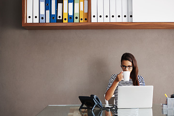 Image showing Coffee, laptop and business woman in an office for planning, management and checking email on wall background. Tea, relax and female manager online for project, proposal or creative idea research