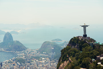 Image showing Brazil, monument and aerial of Christ the Redeemer on hill for tourism, sightseeing and travel destination. Traveling, Rio de Janeiro and drone view of statue, sculpture and city landmark on mountain