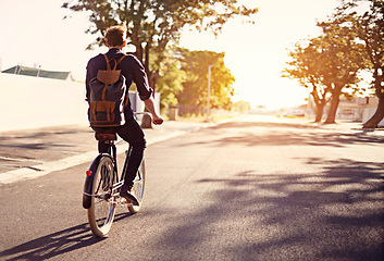 Image showing Bicycle, transport and back of man in road with lens flare for exercise, commute and cycling in morning. Travel, city and male cyclist on bike for eco friendly traveling, carbon footprint and journey