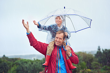 Image showing Other, child or family with an umbrella in rain weather outdoor for fun, happiness and quality time. Man and boy kid in nature with protection from water drops with freedom while playing in winter