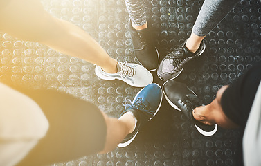 Image showing Feet, shoes and training in circle for fitness or exercise with solidarity for workout with teamwork. Group, class and sneakers for cardio with people to support for motivation and a commitment.