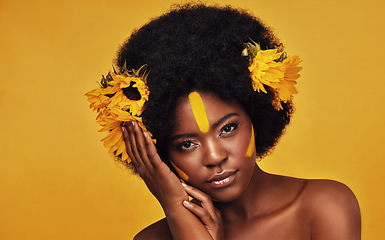 Image showing Makeup, sunflower and art with portrait of black woman in studio for beauty, creative or spring. Natural, cosmetic and floral with face of model on yellow background for glow, self love or confidence