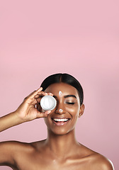 Image showing Smile, skincare and woman with cream container in studio isolated on pink background mockup space. Eyes closed, creme cosmetics and Indian female model with lotion, moisturizer product or dermatology