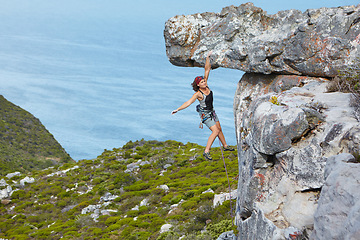 Image showing Fitness, mountain and woman rock climbing, exercise and nature with wellness, balance and hobby. Female person, girl or mountaineer with tools, environment or workout with a view or healthy lifestyle