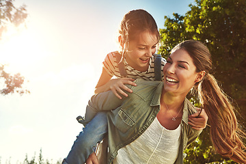 Image showing Piggyback, happy and a mother and child in nature for bonding, happiness and love in summer. Laughing, relax and a mom and a girl kid in a park or garden for playing together and quality time