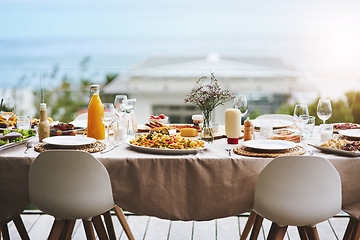 Image showing Party, event and table with food, drinks and outdoor for fun, bonding and delicious meal. Chairs, outside and lunch with glasses, juice and social gathering for eating, restaurant and celebration