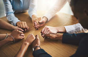 Image showing Unity, compassion and people holding hands by a table at a group counseling or therapy session. Gratitude, trust and friends in a circle for praying together for religion, community and connection.