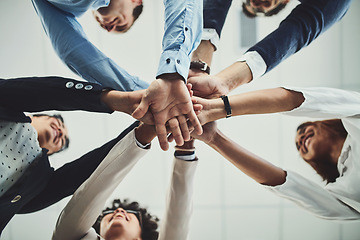 Image showing Hands together, business people and solidarity with low angle, support and team huddle with collaboration. Group of employees working in office, teamwork and mission with workforce and hand stack