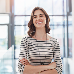 Image showing Confidence, crossed arms and portrait of a woman in a office with a happy, good and positive mindset. Happiness, smile and professional corporate female employee standing in the modern workplace.