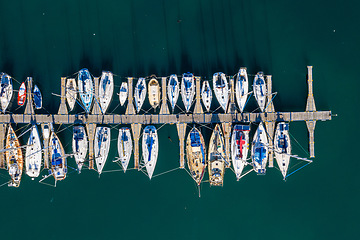 Image showing Landscape, port and drone of boats on the water for travel, sailing and holiday in Spain. Environment, marine and above of sea transportation at a harbor for vacation, cruise and traveling adventure