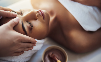 Image showing Woman, hands and face massage at spa in relax for skincare beauty treatment on bed at resort. Calm female relaxing with eyes closed or resting in physical therapy, healthy wellness or cosmetic facial