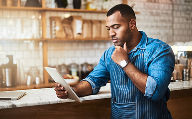 Image showing Focus, tablet and thinking with man in coffee shop for online, entrepreneurship and startup. Retail, technology and food industry with small business owner in restaurant for barista, store and cafe