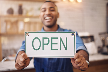 Image showing Open, sign and closeup of man in shop, store and advertising notice of retail shopping time, board or trading information. Hands of happy cafe owner with opening banner, welcome and startup services