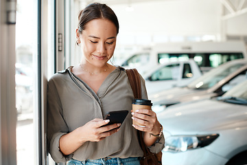 Image showing Phone, coffee and woman at a car dealership typing a text message or scrolling on social media. Communication, technology and female person browsing on a mobile app with a cellphone in a showroom.