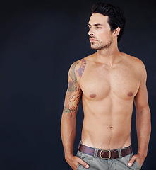 Image showing Thinking, mockup and shirtless with a sexy man in studio on a dark background for masculine desire. Idea, tattoo and aesthetic with a handsome young male model posing topless for manly sensuality