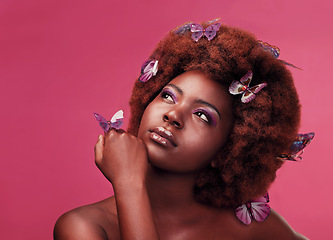 Image showing Beauty, makeup and woman with butterflies in a studio with a cosmetic, natural and elegant face. Cosmetics, fantasy and young African female model posing with beautiful insects by a pink background.