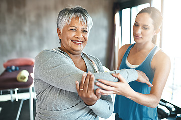 Image showing Stretching, support and old woman with personal trainer for fitness, wellness or rehabilitation. Health, workout or retirement with senior patient and female trainer in gym for arm warm up training