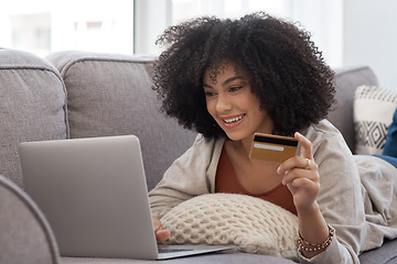 Image showing Couch, laptop and woman with a credit card, online shopping and ecommerce with happiness, home and discount. Female person, customer or client on a sofa, technology and retail with payment and buying