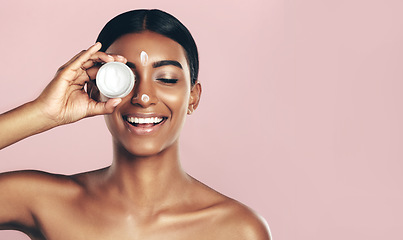Image showing Happy, skincare and woman with cream container in studio isolated on pink background mockup space. Eyes closed, creme cosmetics and Indian female model with lotion, moisturizer product or dermatology