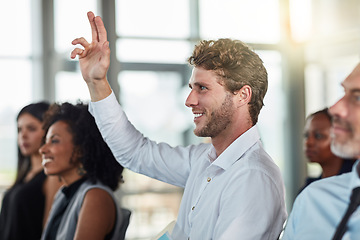 Image showing Smile, business man and hands raised for questions at conference, seminar or meeting. Male person, happy and hand up for question, asking or answer, vote and training at workshop presentation event.