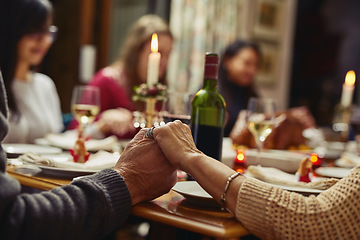 Image showing Family, people holding hands in prayer and at dinner table with champagne. Praying for food, support or love and adults gather for celebration or thanksgiving in dining room at their home.