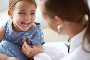 Image showing Happy child, girl and stethoscope of doctor for medical consulting, healthy lungs and listening to heartbeat. Face of laughing kid, pediatrician and chest assessment for healthcare analysis in clinic