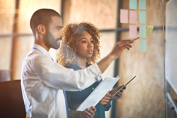 Image showing Coworkers, planning or brainstorming on tablet in modern office or paperwork, strategy conversation and sticky notes. Business people, documents and moodboard for idea and corporate company workplace