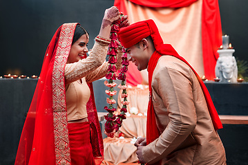 Image showing Celebration, young Indian married couple happy and at wedding or special event. Festival or romance, culture or marriage and smiling people with woman putting necklace on man neck with veil.